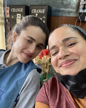 Picture of Tracy Vilar with her friend in light pink t-shirt with a cute smile